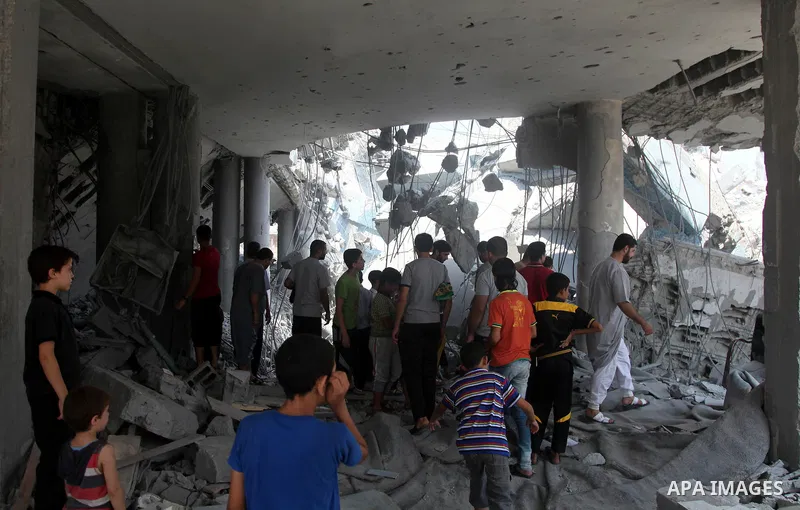 Palestinians inspect the damage at a mosque which witnesses said was destroyed by an Israel air strike during the offensive, on the second day of a five-day ceasefire, in Gaza city on August 15, 2014. Israel and Palestin...