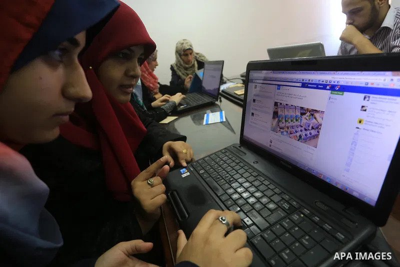 Palestinian youths take part in a campaign to boycott Israeli goods following the Israeli military offensive on Gaza Strip in Gaza City on Aug. 16, 2014. Photo by Mohammed Asad