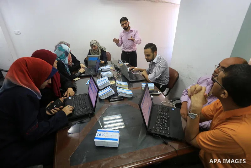 Palestinian youths take part in a campaign to boycott Israeli goods following the Israeli military offensive on Gaza Strip in Gaza City on Aug. 16, 2014. Photo by Mohammed Asad