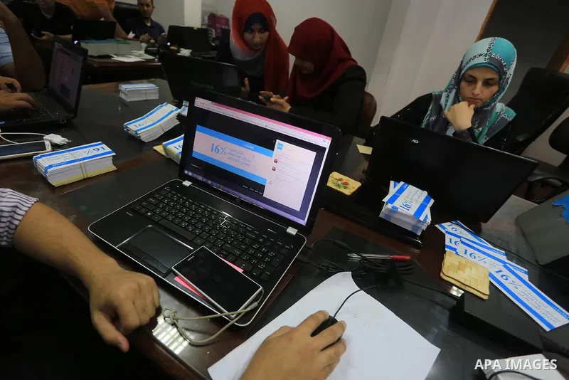 Palestinian youths take part in a campaign to boycott Israeli goods following the Israeli military offensive on Gaza Strip in Gaza City on Aug. 16, 2014. Photo by Mohammed Asad