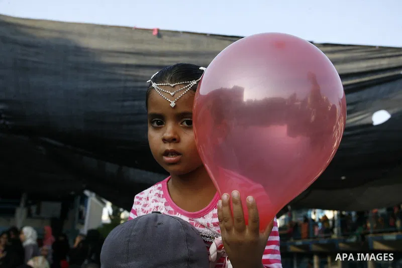 People gather around a homeless Palestinian bride during her wedding ceremony at a United Nations-run school sheltering displaced Palestinians from the Israeli offensive, in Rafah in the southern Gaza Strip August 17, 20...