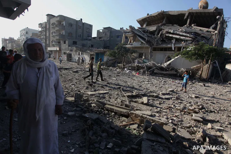 Palestinians inspect a house that witnesses said was damaged during an Israeli air strike in the Jabalia Palestinian refugee camp in the Gaza Strip on August 20, 2014. Hamas said that an Israeli air strike killed the wif...