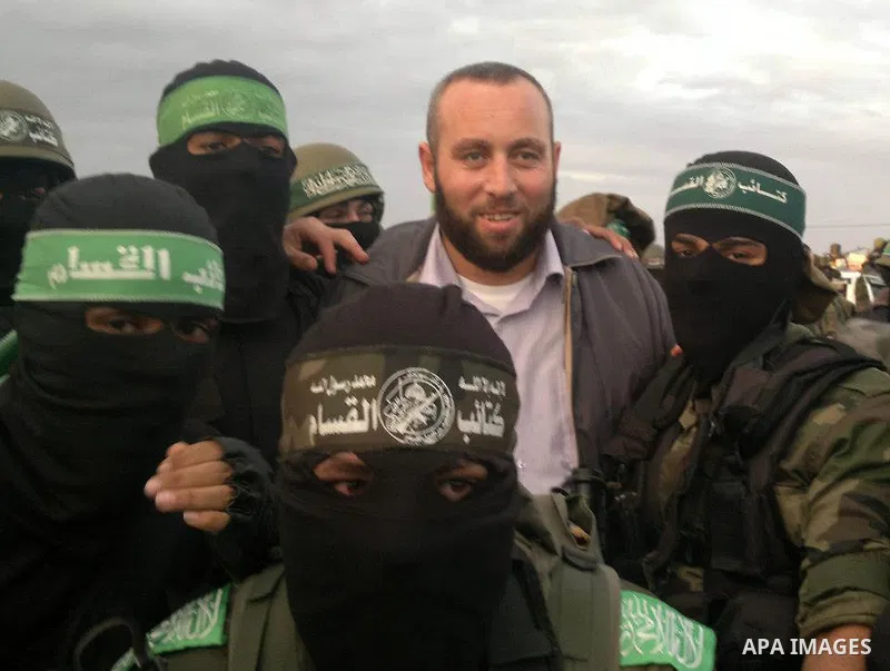 A handout picture dated February 26, 2014 and released by Hamas Press Office on August 21, 2014, shows the senior Hamas commander, Raed al-Atar (L), in the southern Gaza Strip town of Rafah. Three senior Hamas commanders...