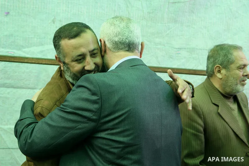 A handout picture dated February 26, 2014 and released by Hamas Press Office on August 21, 2014, shows the top Hamas official in Gaza Ismail Haniya (R) greeting fellow senior Hamas commander, Mohammed Abu Shamala (L), in...