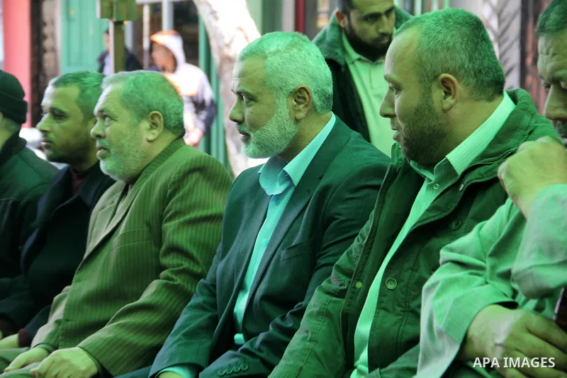 A handout picture dated February 26, 2014 and released by Hamas Press Office on August 21, 2014, shows the senior Hamas commander, Raed al-Atar (R), with the top Hamas official in Gaza Ismail Haniya (L) in the southern G...