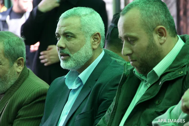 A handout picture dated February 26, 2014 and released by Hamas Press Office on August 21, 2014, shows the senior Hamas commander, Raed al-Atar (R), with the top Hamas official in Gaza Ismail Haniya (L) in the southern G...
