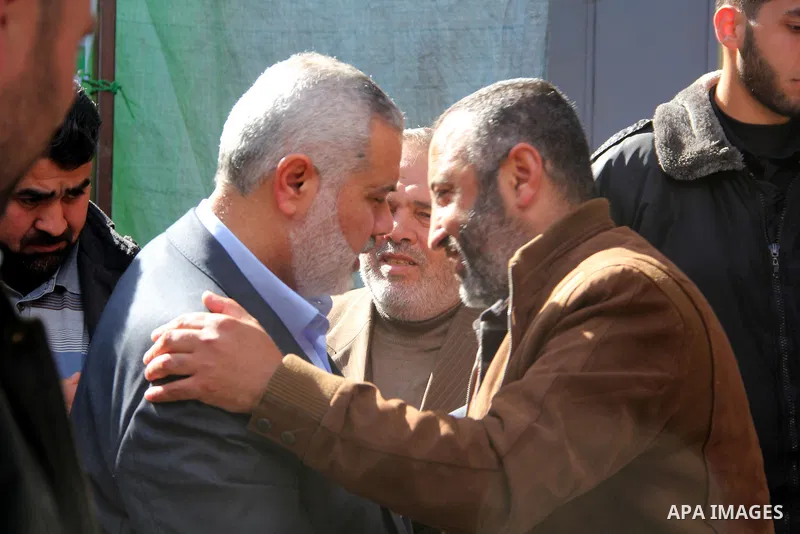 A handout picture dated February 26, 2014 and released by Hamas Press Office on August 21, 2014, shows the top Hamas official in Gaza Ismail Haniya (R) greeting fellow senior Hamas commander, Mohammed Abu Shamala (L), in...