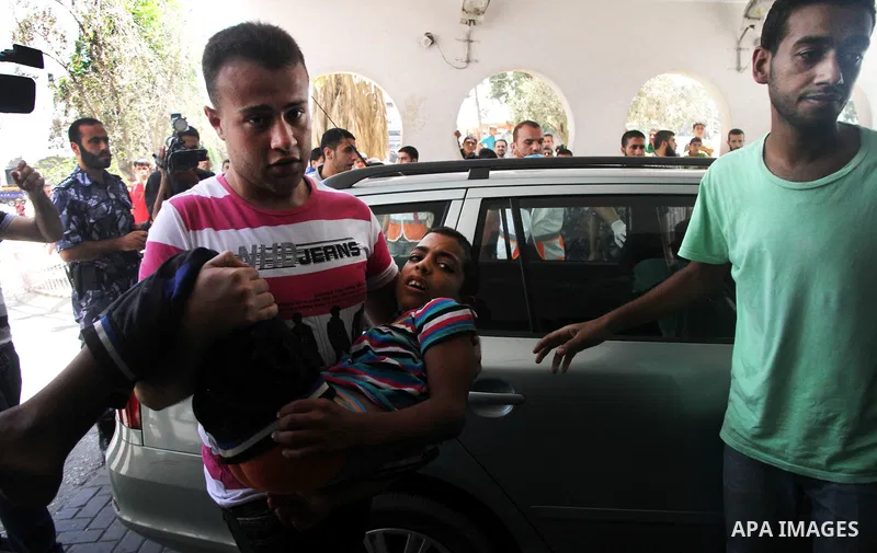 Palestinian an injured boy, whom medics said was injured in an Israeli air strike, in Gaza City August 21, 2014. Three senior Hamas commanders and four children were among at least 15 Palestinians killed in Gaza as Israe...