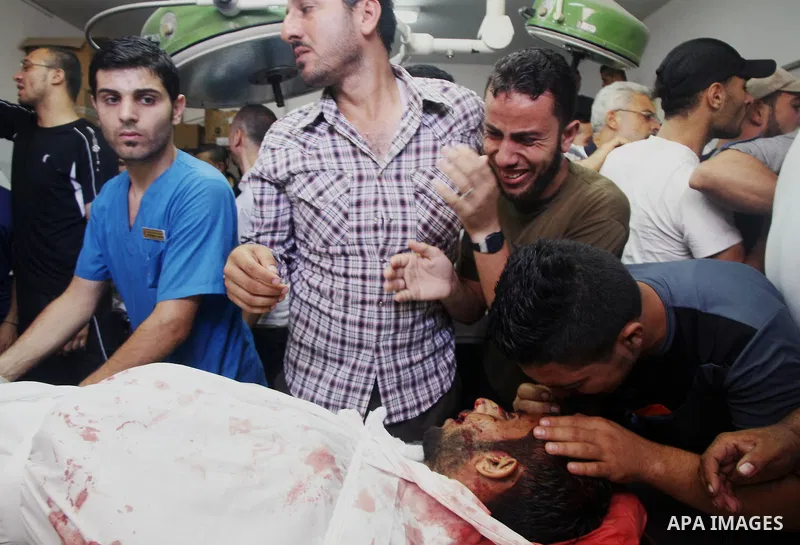 Palestinians mourn the death of their relatives Abu Nahel family's, killed in an Israeli military strike, at Gaza city's Al-Shifa hospital on August 21, 2014. Three senior Hamas commanders and four children were among at...