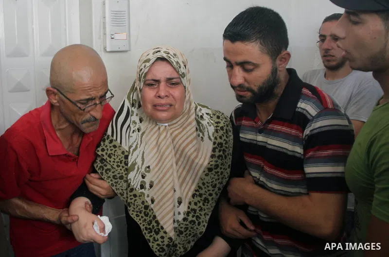 Palestinians mourn the death of their relatives Abu Nahel family's, killed in an Israeli military strike, at Gaza city's Al-Shifa hospital on August 21, 2014. Three senior Hamas commanders and four children were among at...