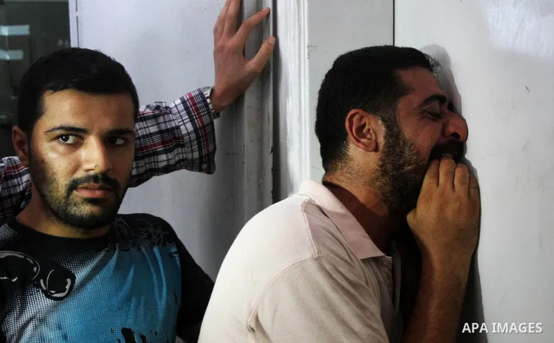 Palestinians mourn the death of their relatives Abu Nahel family's, killed in an Israeli military strike, at Gaza city's Al-Shifa hospital on August 21, 2014. Three senior Hamas commanders and four children were among at...