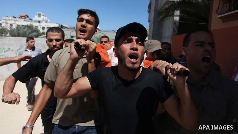 Palestinian mourners carry the body Mohammed Barhoum, one of three senior Hamas commanders who was killed in an Israeli air strike, mourn during his funeral in Rafah in the southern Gaza Strip August 21, 2014. Israel kil...