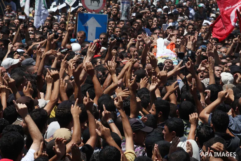 Palestinians carry the bodies of three senior Hamas commanders, who were killed in an Israeli air strike, during their funeral in Rafah in the southern Gaza Strip August 21, 2014. Israel killed three senior Hamas command...