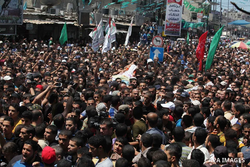 Palestinians carry the bodies of three senior Hamas commanders, who were killed in an Israeli air strike, during their funeral in Rafah in the southern Gaza Strip August 21, 2014. Israel killed three senior Hamas command...