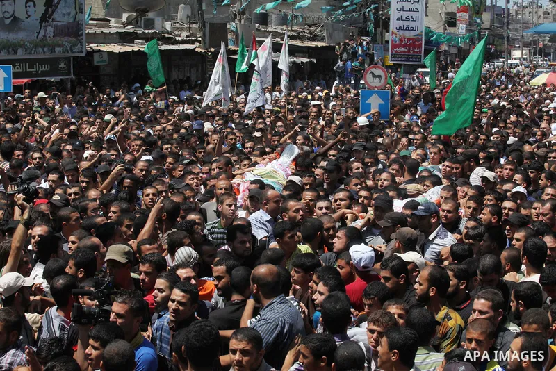 Palestinians carry the bodies of three senior Hamas commanders, who were killed in an Israeli air strike, during their funeral in Rafah in the southern Gaza Strip August 21, 2014. Israel killed three senior Hamas command...