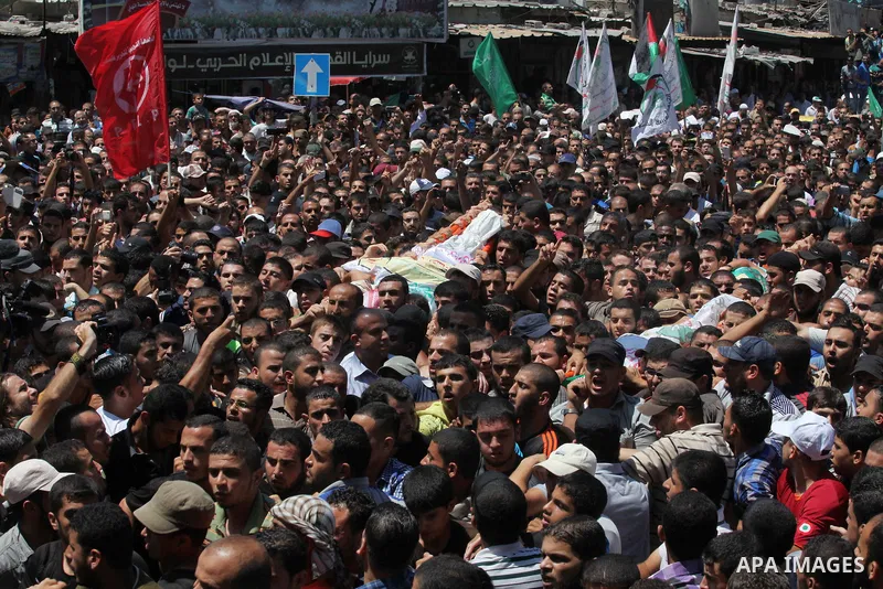 Palestinians carry the bodies of three senior Hamas commanders, who were killed in an Israeli air strike, during their funeral in Rafah in the southern Gaza Strip August 21, 2014. Israel killed three senior Hamas command...