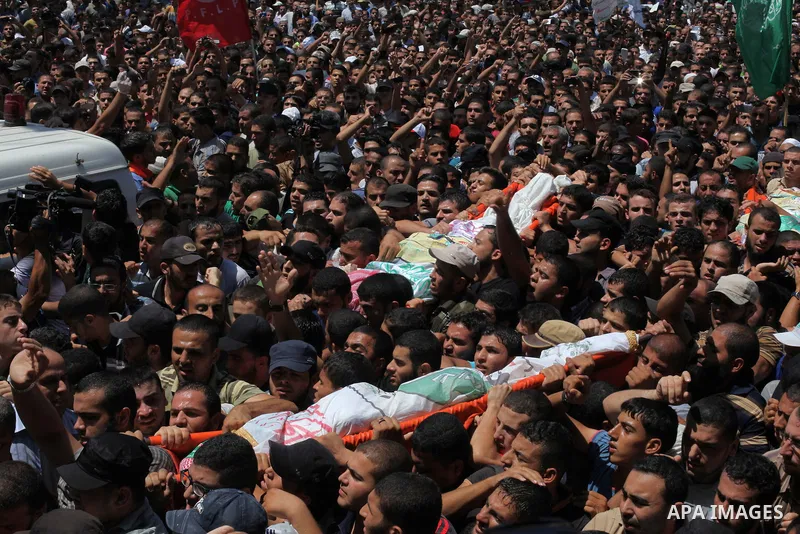Palestinians carry the bodies of three senior Hamas commanders, who were killed in an Israeli air strike, during their funeral in Rafah in the southern Gaza Strip August 21, 2014. Israel killed three senior Hamas command...