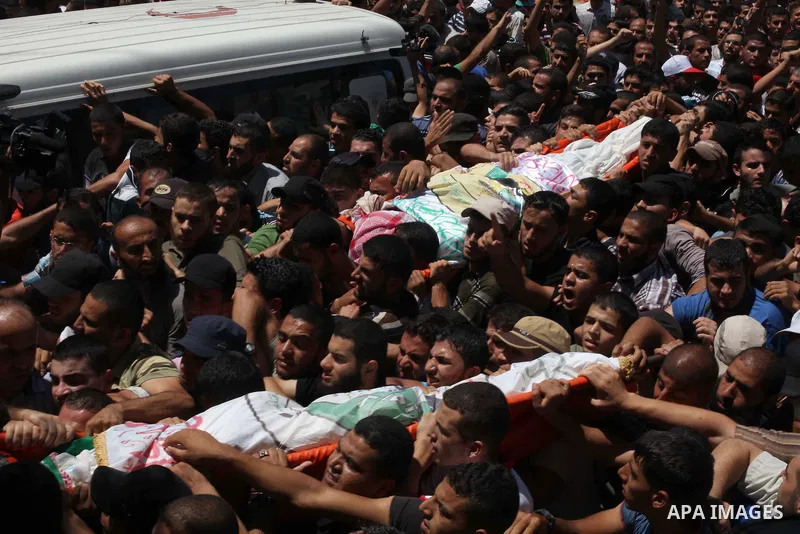 Palestinians carry the bodies of three senior Hamas commanders, who were killed in an Israeli air strike, during their funeral in Rafah in the southern Gaza Strip August 21, 2014. Israel killed three senior Hamas command...