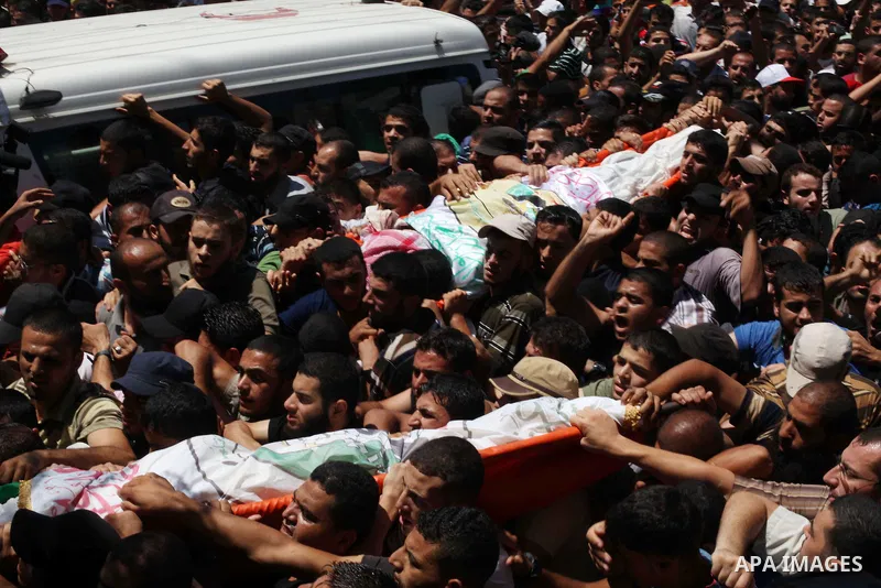 Palestinians carry the bodies of three senior Hamas commanders, who were killed in an Israeli air strike, during their funeral in Rafah in the southern Gaza Strip August 21, 2014. Israel killed three senior Hamas command...