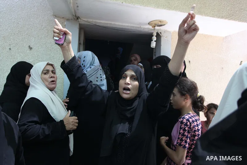 Palestinian relatives of Mohammed Abu Shammala, one of three senior Hamas commanders who were killed in an Israeli air strike, mourns during his funeral in Rafah in the southern Gaza Strip August 21, 2014. Israel killed...