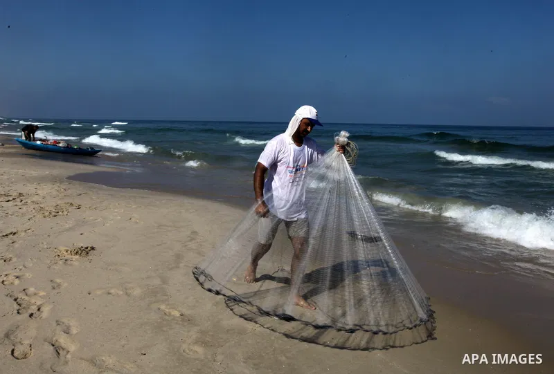 A Palestinian fisherman throws his net into the sea at the beach of Gaza City on August 22, 2014. Since the collapse on Tuesday of a 10-day ceasefire, the Israeli military has ramped up its efforts to hit the leadership...