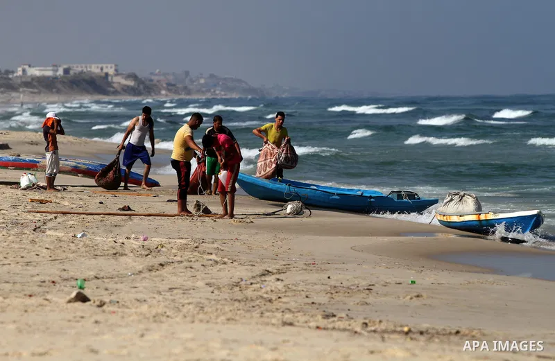 Palestinian fishermen retrieve their net at the beach, in Gaza City on August 22, 2014. Since the collapse on Tuesday of a 10-day ceasefire, the Israeli military has ramped up its efforts to hit the leadership of Hamas's...