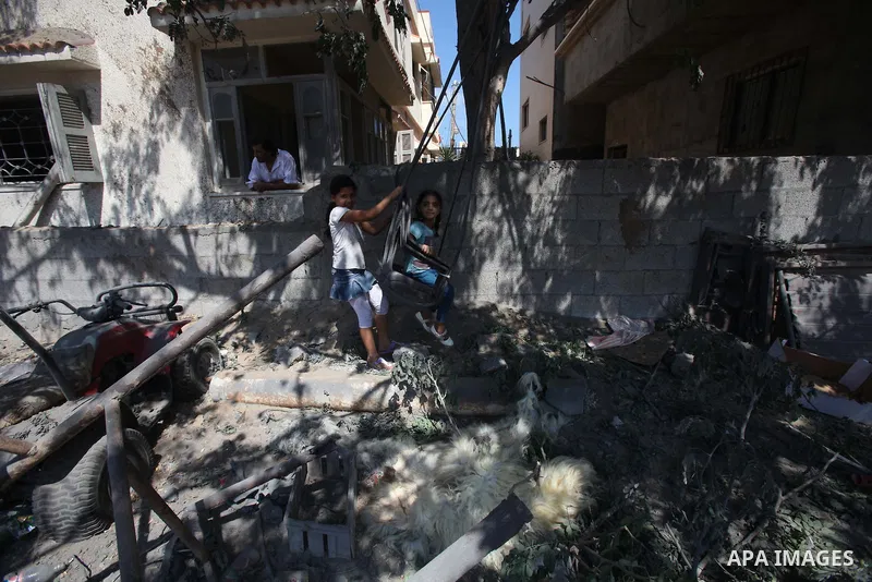 Palestinian children play oustide their family's house, which witnesses said was destroyed in an Israeli air strike, in Gaza City August 22, 2014. Since the collapse on Tuesday of a 10-day ceasefire, the Israeli military...