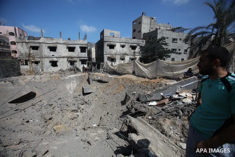 A Palestinian man looks at the remains of a house, which witnesses said was destroyed in an Israeli air strike, in Gaza City August 22, 2014. Since the collapse on Tuesday of a 10-day ceasefire, the Israeli military has...