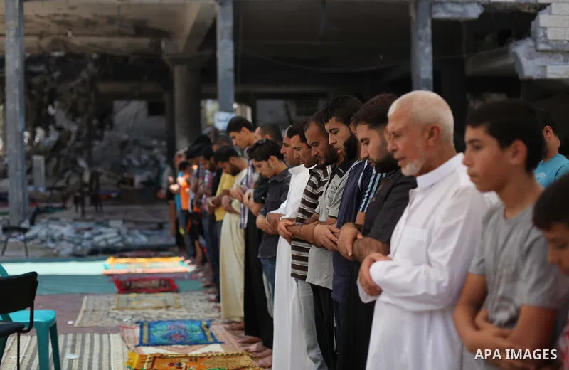 Palestinian worshipers perform Friday prayers next to the remains of a mosque which witnesses said was destroyed by an Israel air strike during the offensive, in Gaza City August 22, 2014. Since the collapse on Tuesday o...