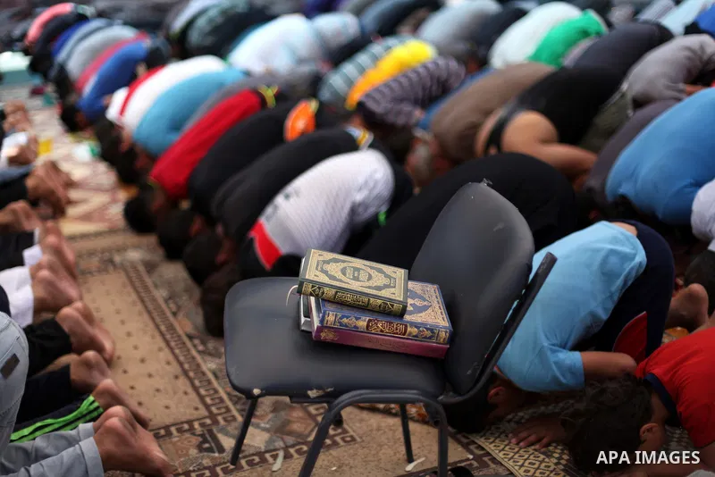 Palestinian worshipers perform Friday prayers next to the remains of a mosque which witnesses said was destroyed by an Israel air strike during the offensive, in Gaza City August 22, 2014. Since the collapse on Tuesday o...