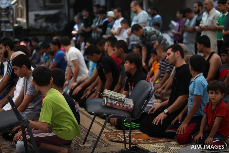 Palestinian worshipers perform Friday prayers next to the remains of a mosque which witnesses said was destroyed by an Israel air strike during the offensive, in Gaza City August 22, 2014. Since the collapse on Tuesday o...