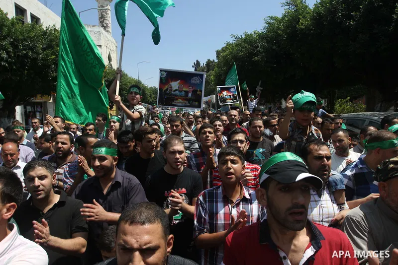 Supporters of the Palestinian Islamist Hamas movement gather during a demonstration in the West Bank city of Nablus to support people in the Gaza Strip on August 22, 2014. Four Palestinians were killed in new Israeli air...