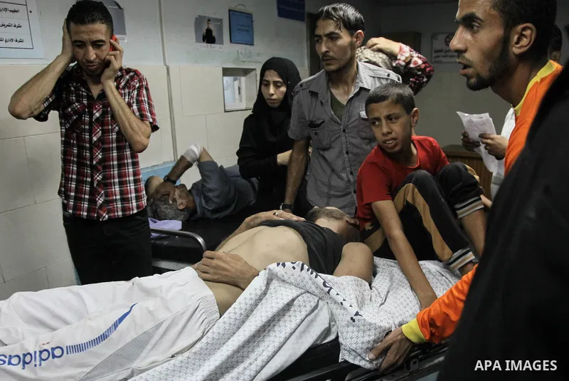 A wounded Palestinian man receives medical treatment in the corridor of the al-Shifa hospital after an Israeli air strike on Gaza City on August 22, 2014. Israeli Prime Minister Benjamin Netanyahu pledged that "Hamas wil...