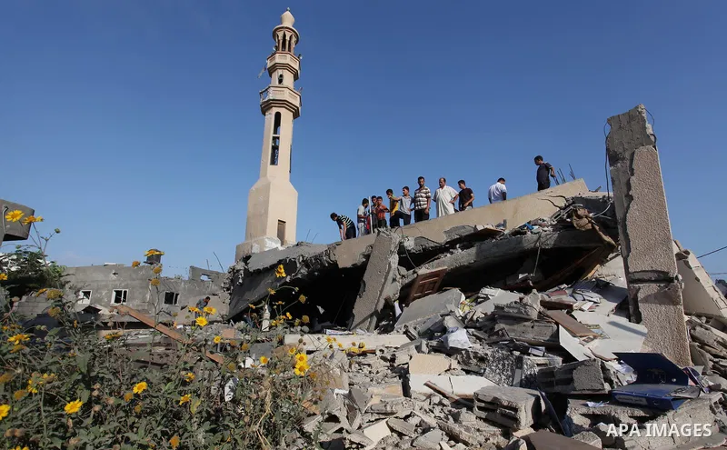 Palestinians inspect the remains of a mosque , which witnesses said was destroyed in an Israeli air strike, in Khan Younis in the southern Gaza strip August 23, 2014. Hamas-led gunmen in Gaza executed 18 Palestinians acc...