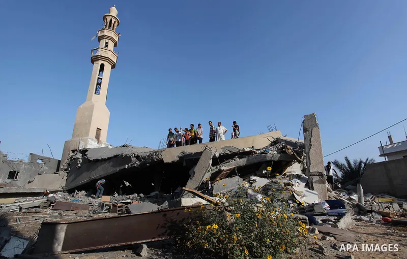 Palestinians inspect the remains of a mosque , which witnesses said was destroyed in an Israeli air strike, in Khan Younis in the southern Gaza strip August 23, 2014. Hamas-led gunmen in Gaza executed 18 Palestinians acc...