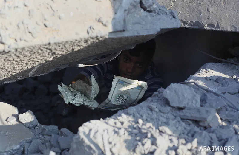 A Palestinian boy inspects the remains of a mosque , which witnesses said was destroyed in an Israeli air strike, in Khan Younis in the southern Gaza strip August 23, 2014. Hamas-led gunmen in Gaza executed 18 Palestinia...
