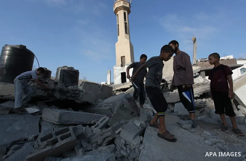 Palestinians inspect the remains of a mosque , which witnesses said was destroyed in an Israeli air strike, in Khan Younis in the southern Gaza strip August 23, 2014. Hamas-led gunmen in Gaza executed 18 Palestinians acc...