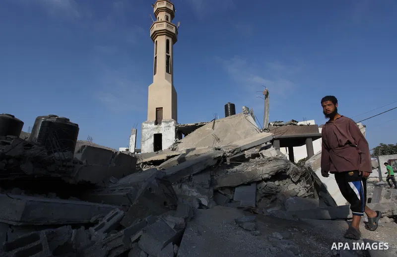 A Palestinian man walks past the remains of a mosque , which witnesses said was destroyed in an Israeli air strike, in Khan Younis in the southern Gaza strip August 23, 2014. Hamas-led gunmen in Gaza executed 18 Palestin...