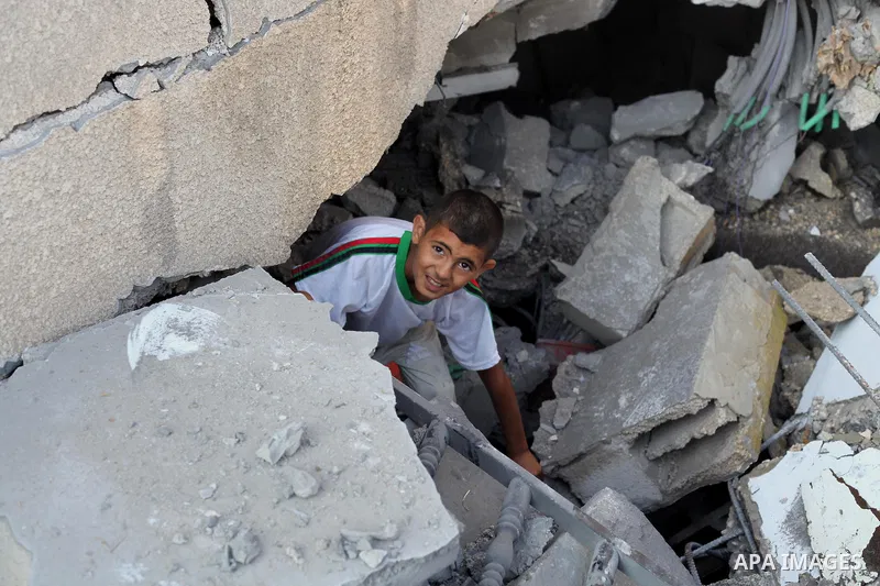 A Palestinian boy inspects the remains of a mosque , which witnesses said was destroyed in an Israeli air strike, in Khan Younis in the southern Gaza strip August 23, 2014. Hamas-led gunmen in Gaza executed 18 Palestinia...