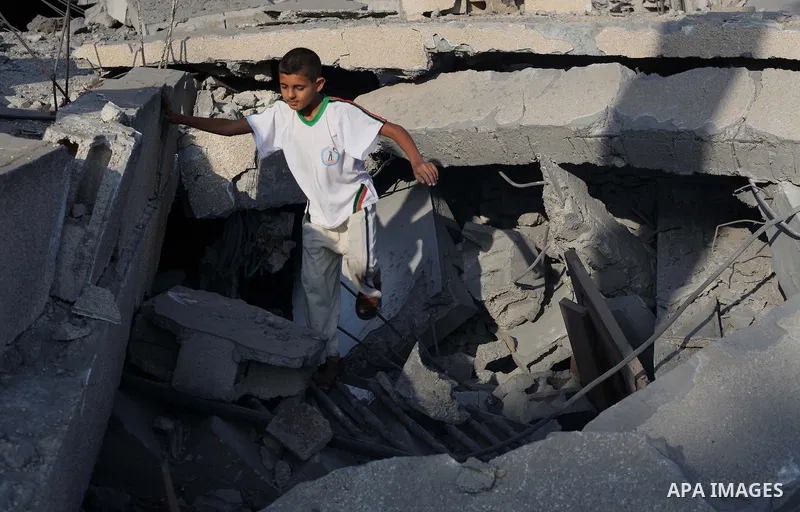 A Palestinian boy inspects the remains of a mosque , which witnesses said was destroyed in an Israeli air strike, in Khan Younis in the southern Gaza strip August 23, 2014. Hamas-led gunmen in Gaza executed 18 Palestinia...