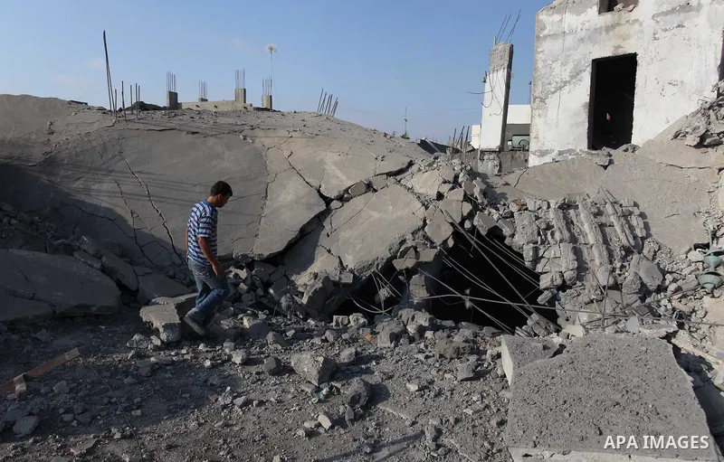 A Palestinian man inspects the remains of a mosque , which witnesses said was destroyed in an Israeli air strike, in Khan Younis in the southern Gaza strip August 23, 2014. Hamas-led gunmen in Gaza executed 18 Palestinia...