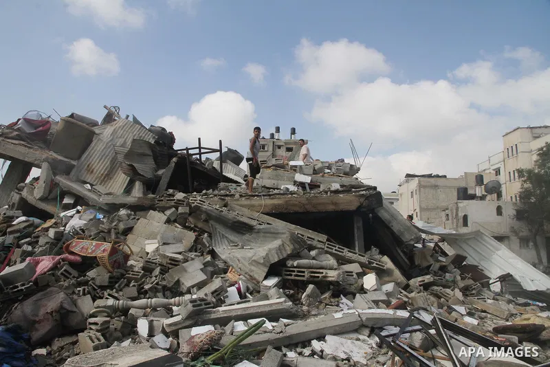 Palestinians search for their belongings amid the remains of their house, which witnesses said was destroyed in an Israeli air strike, in Gaza City August 23, 2014. Hamas-led gunmen in Gaza executed 18 Palestinians accus...