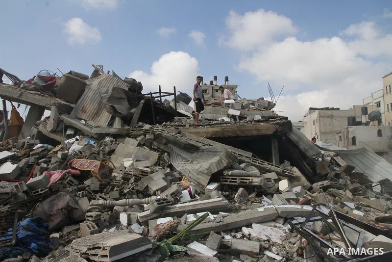 Palestinians search for their belongings amid the remains of their house, which witnesses said was destroyed in an Israeli air strike, in Gaza City August 23, 2014. Hamas-led gunmen in Gaza executed 18 Palestinians accus...