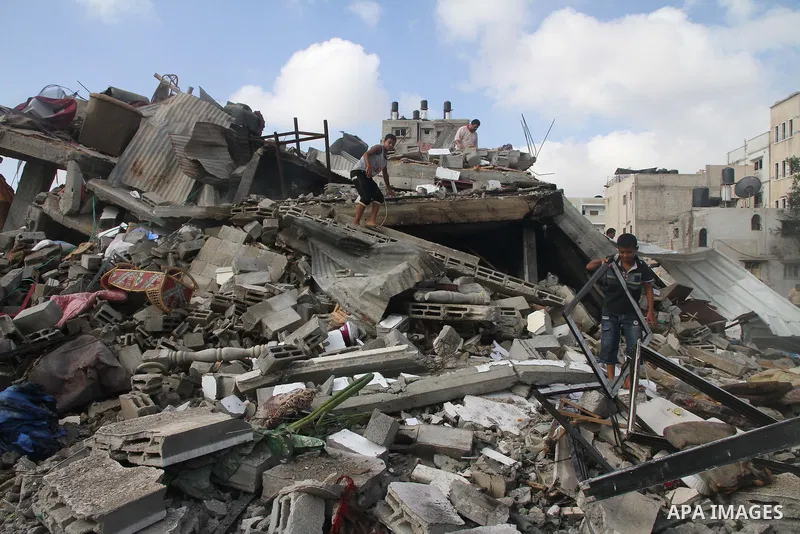 Palestinians search for their belongings amid the remains of their house, which witnesses said was destroyed in an Israeli air strike, in Gaza City August 23, 2014. Hamas-led gunmen in Gaza executed 18 Palestinians accus...