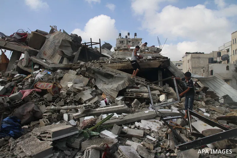 Palestinians search for their belongings amid the remains of their house, which witnesses said was destroyed in an Israeli air strike, in Gaza City August 23, 2014. Hamas-led gunmen in Gaza executed 18 Palestinians accus...
