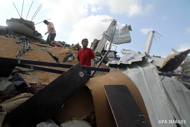 Palestinians search for their belongings amid the remains of their house, which witnesses said was destroyed in an Israeli air strike, in Gaza City August 23, 2014. Hamas-led gunmen in Gaza executed 18 Palestinians accus...