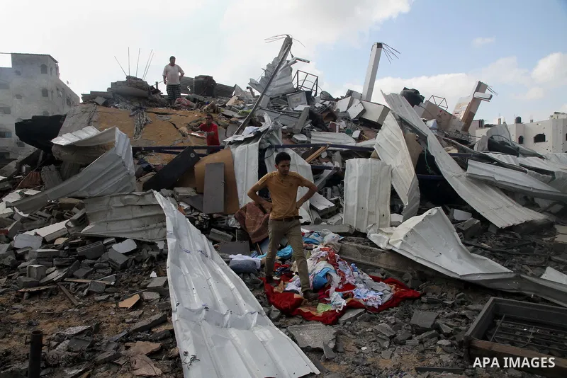 Palestinians search for their belongings amid the remains of their house, which witnesses said was destroyed in an Israeli air strike, in Gaza City August 23, 2014. Hamas-led gunmen in Gaza executed 18 Palestinians accus...