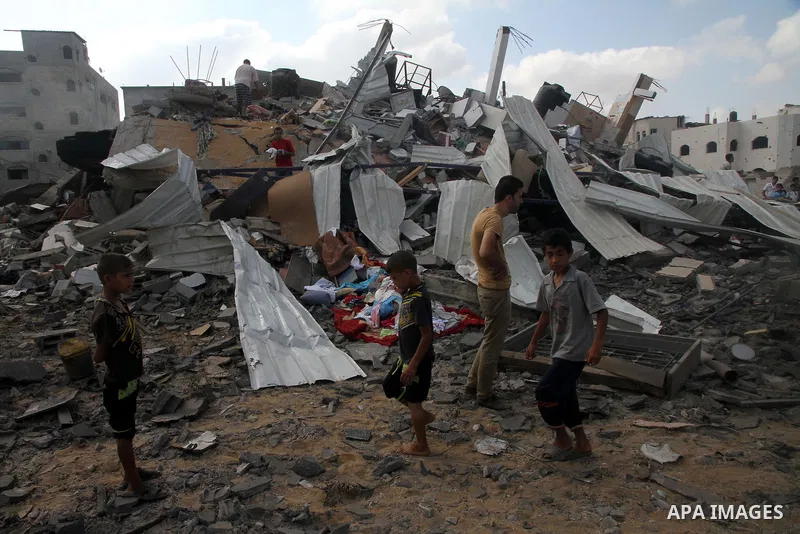 Palestinians search for their belongings amid the remains of their house, which witnesses said was destroyed in an Israeli air strike, in Gaza City August 23, 2014. Hamas-led gunmen in Gaza executed 18 Palestinians accus...