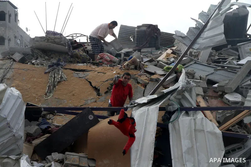 Palestinians search for their belongings amid the remains of their house, which witnesses said was destroyed in an Israeli air strike, in Gaza City August 23, 2014. Hamas-led gunmen in Gaza executed 18 Palestinians accus...