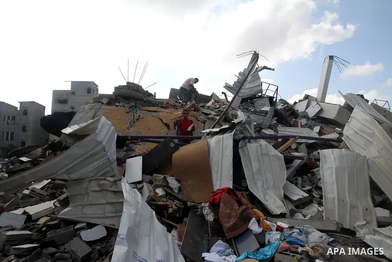 Palestinians search for their belongings amid the remains of their house, which witnesses said was destroyed in an Israeli air strike, in Gaza City August 23, 2014. Hamas-led gunmen in Gaza executed 18 Palestinians accus...
